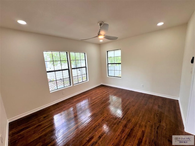 spare room featuring ceiling fan and dark wood-type flooring