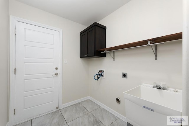 laundry area featuring electric dryer hookup, cabinets, sink, washer hookup, and light tile patterned floors