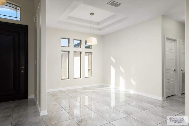 entryway with a raised ceiling