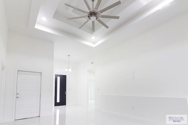 interior details with a ceiling fan, recessed lighting, and a raised ceiling