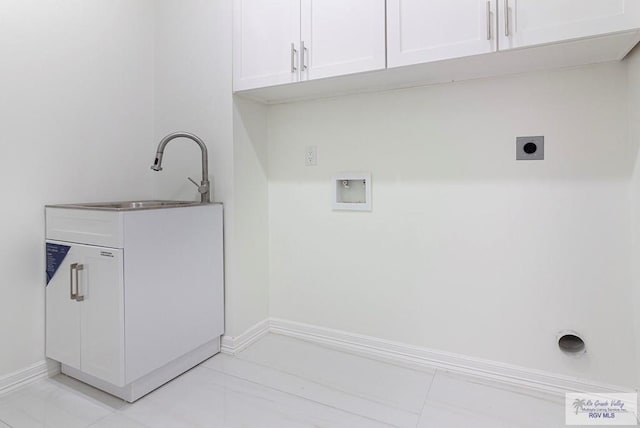 washroom featuring washer hookup, a sink, baseboards, cabinet space, and electric dryer hookup