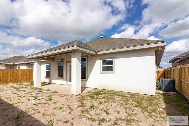 back of house with a fenced backyard, a patio area, cooling unit, and stucco siding