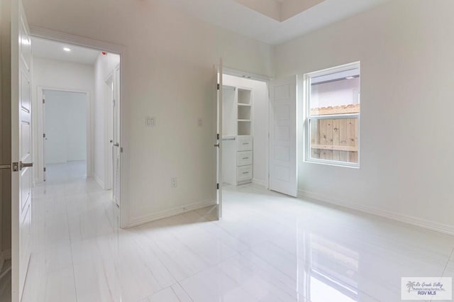 interior space with a spacious closet and baseboards