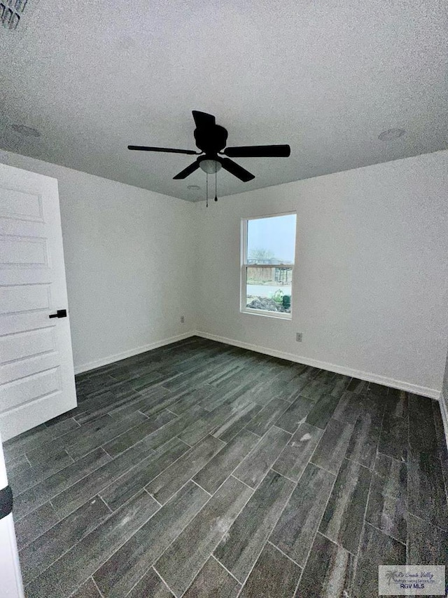 spare room with a textured ceiling and ceiling fan