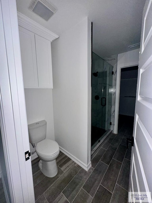 bathroom with walk in shower and toilet