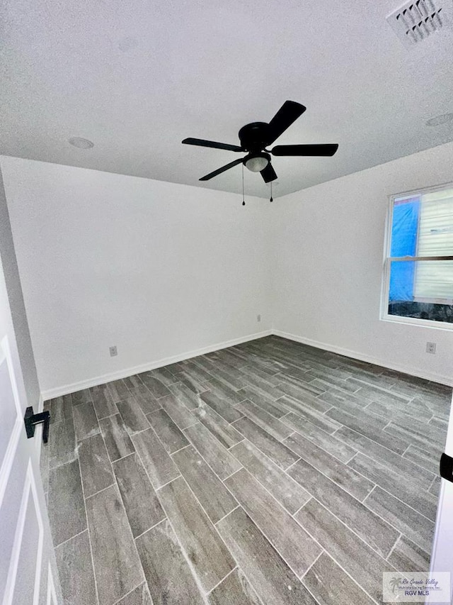 empty room featuring a textured ceiling and ceiling fan