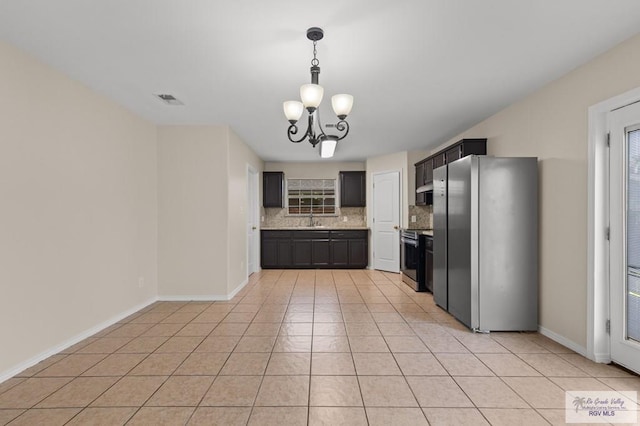 2344 Munich St, Brownsville, TX 78520 - kitchen featuring stainless steel appliances, tasteful backsplash, a chandelier, and light tile patterned floors