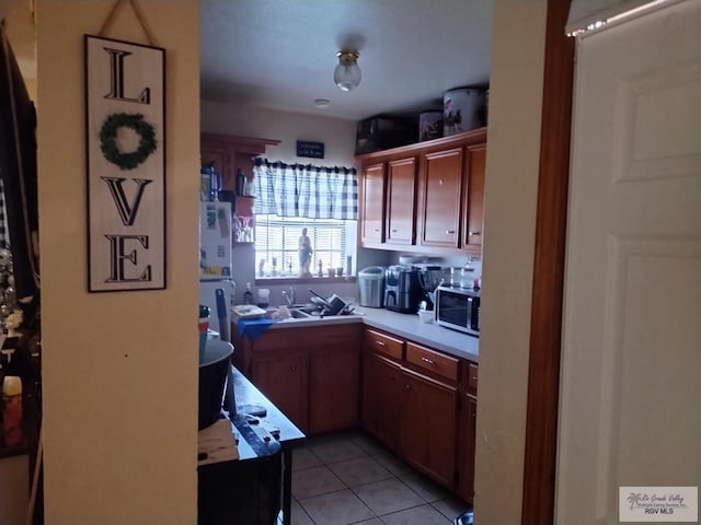 kitchen with sink and light tile patterned flooring