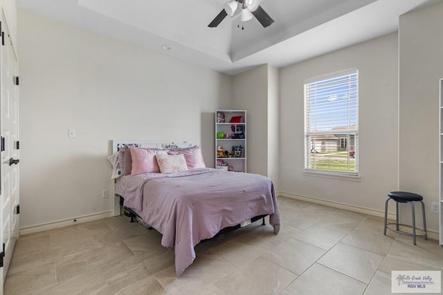 16756 E Barger Ct, Harlingen, TX 78552 - bedroom featuring a tray ceiling, baseboards, a ceiling fan, and light tile patterned flooring
