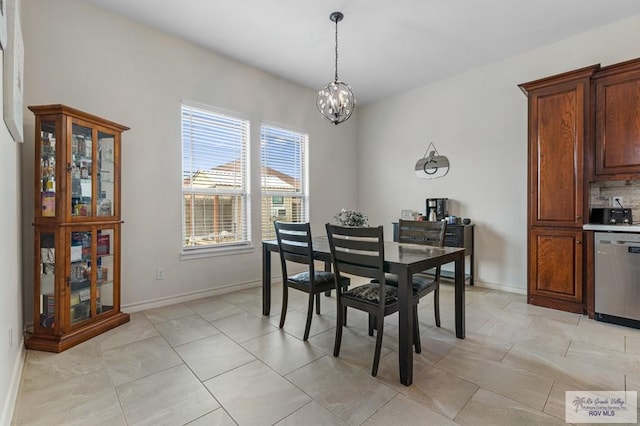 16756 E Barger Ct, Harlingen, TX 78552 - dining room featuring a chandelier, baseboards, and light tile patterned floors