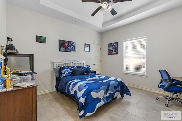 16756 E Barger Ct, Harlingen, TX 78552 - bedroom with a raised ceiling, baseboards, and ceiling fan