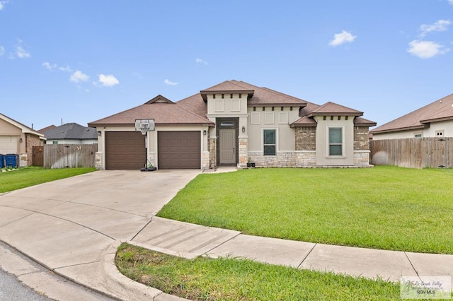 16756 E Barger Ct, Harlingen, TX 78552 - prairie-style house featuring a garage, stone siding, concrete driveway, stucco siding, and a shingled roof