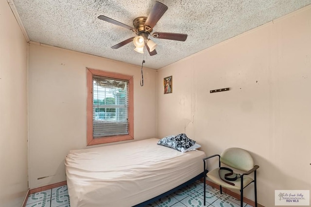 bedroom with a textured ceiling and ceiling fan