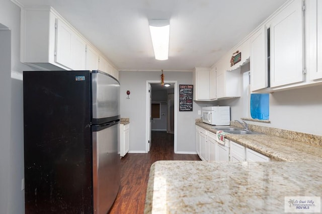 kitchen featuring white cabinetry, stainless steel refrigerator, and dark hardwood / wood-style floors