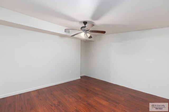 spare room with dark hardwood / wood-style floors and ceiling fan