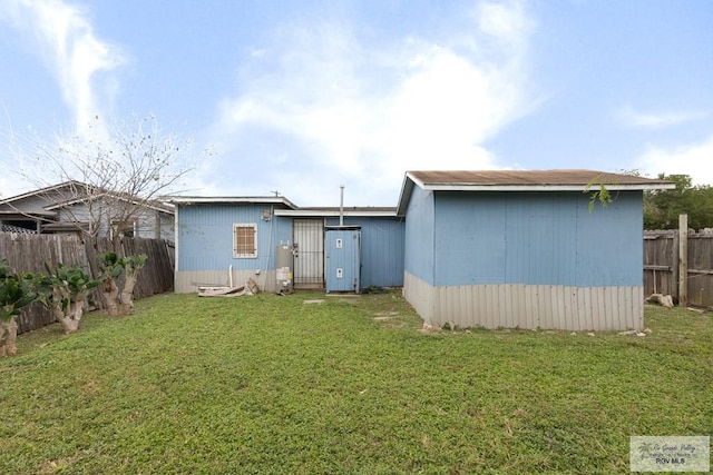 back of house with a yard