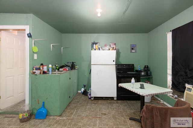 kitchen with black range with electric cooktop and white fridge