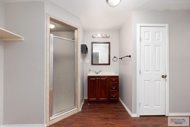 bathroom featuring vanity, an enclosed shower, and hardwood / wood-style flooring