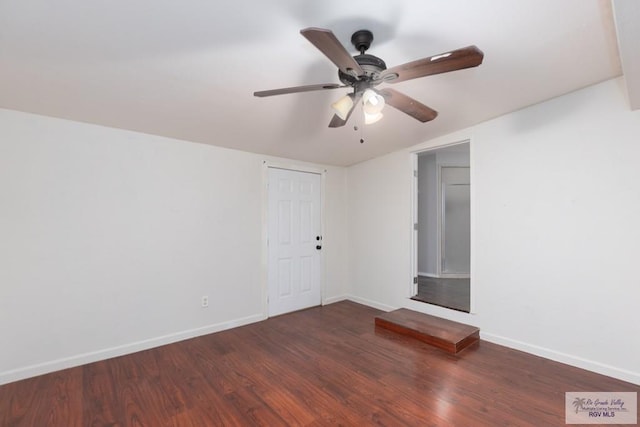 spare room featuring dark hardwood / wood-style flooring and ceiling fan