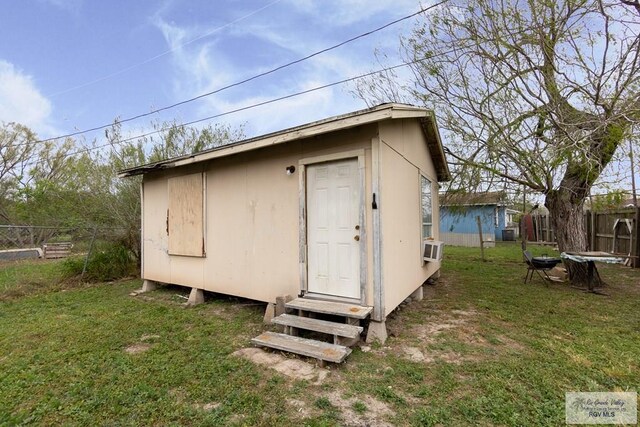 view of outbuilding featuring a yard