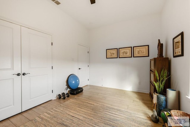 workout area with light hardwood / wood-style flooring