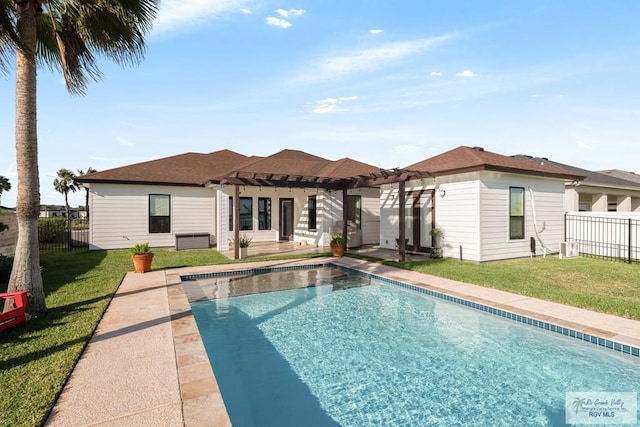 rear view of house featuring a yard, a pergola, a fenced in pool, and a patio