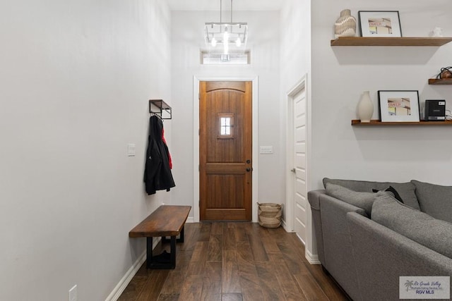 entrance foyer with dark wood-type flooring and a notable chandelier