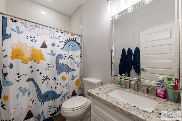 bathroom with toilet, a shower with shower curtain, and vanity