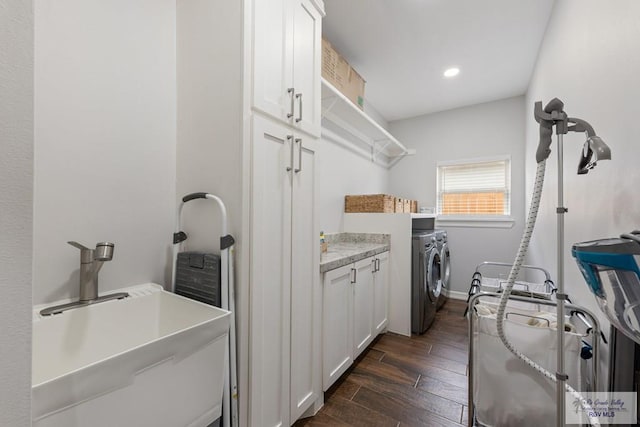 laundry room with cabinets, separate washer and dryer, and sink