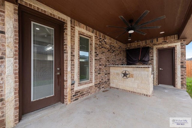 view of patio featuring ceiling fan