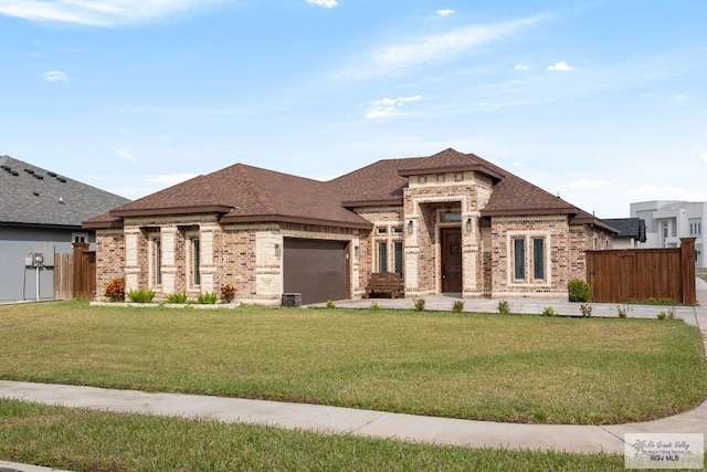 prairie-style house featuring a front lawn and a garage