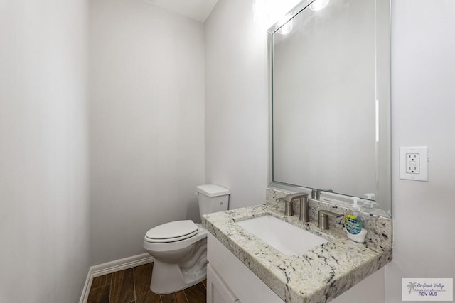 bathroom featuring toilet and vanity