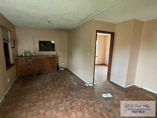 interior space featuring a textured ceiling and parquet floors