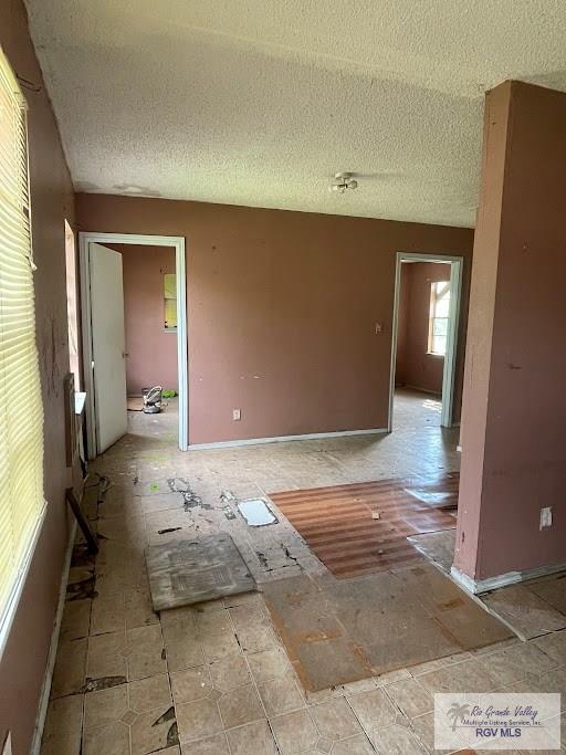 unfurnished room featuring a textured ceiling