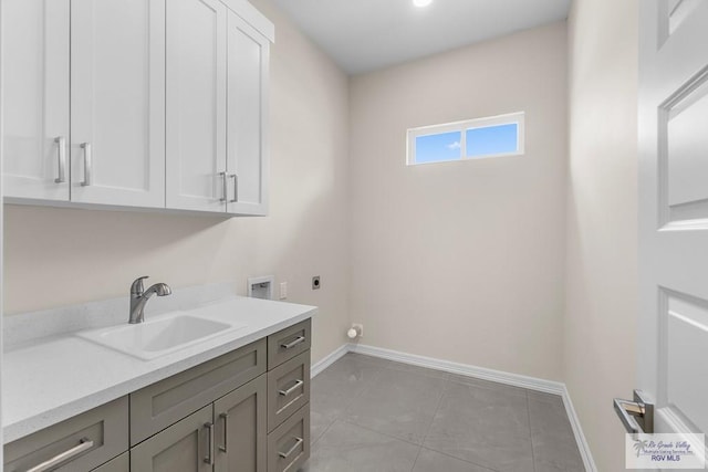 laundry room featuring light tile patterned flooring, washer hookup, electric dryer hookup, sink, and cabinets