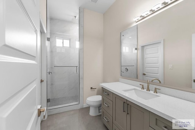 bathroom with tile patterned floors, toilet, vanity, and an enclosed shower