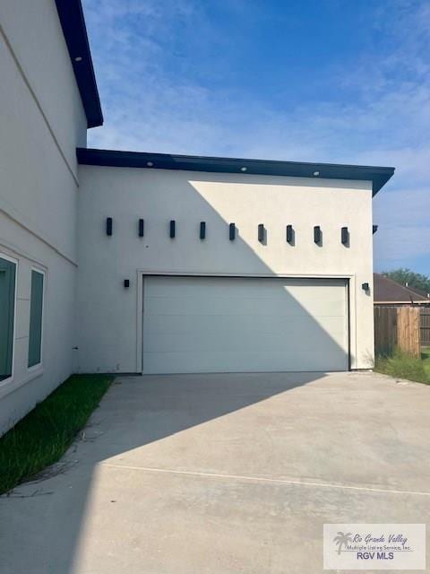4031 Tito Ct Unit 45, Brownsville, TX 78521 - view of home's exterior with a garage, stucco siding, and fence