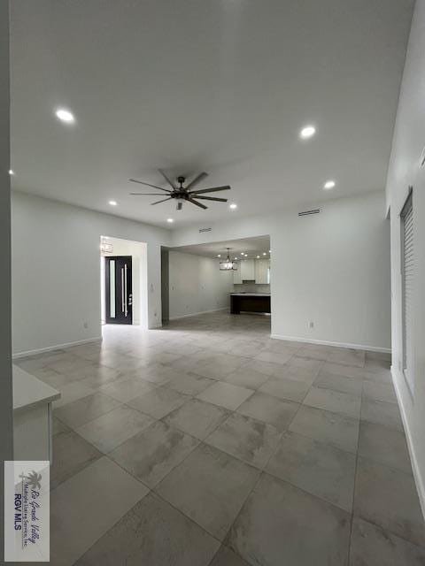 4031 Tito Ct Unit 45, Brownsville, TX 78521 - unfurnished living room with recessed lighting, baseboards, and ceiling fan with notable chandelier