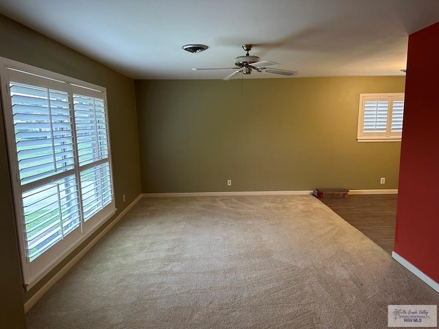 spare room featuring ceiling fan, a healthy amount of sunlight, and carpet