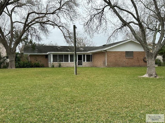 back of property featuring a lawn