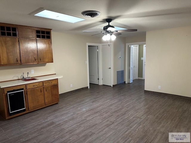 kitchen featuring ceiling fan, dark hardwood / wood-style flooring, and sink