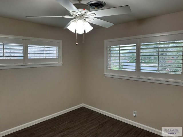 empty room with dark wood-type flooring and ceiling fan