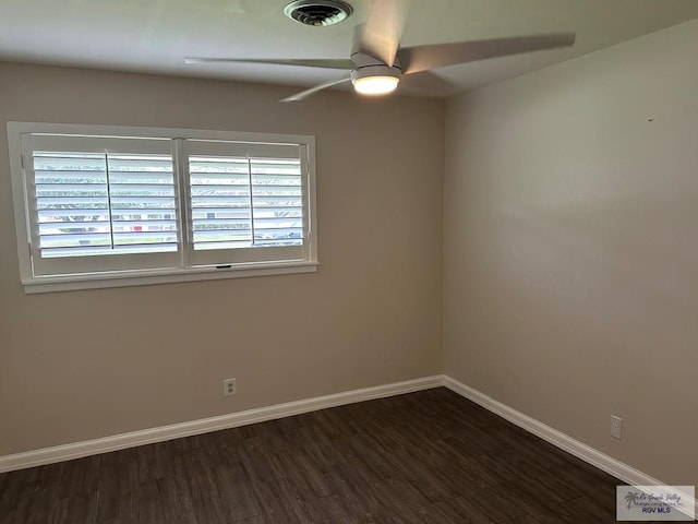 empty room with plenty of natural light, dark hardwood / wood-style floors, and ceiling fan