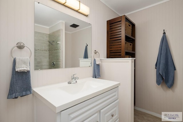1215 Bluebonnet Dr, Brownsville, TX 78521 - bathroom featuring a tile shower, vanity, and crown molding