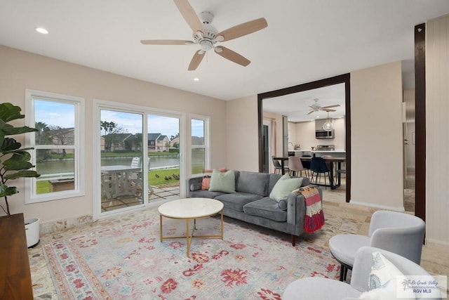 1215 Bluebonnet Dr, Brownsville, TX 78521 - living area featuring a water view, ceiling fan, recessed lighting, and baseboards