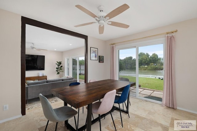 1215 Bluebonnet Dr, Brownsville, TX 78521 - dining room featuring a ceiling fan, a water view, baseboards, and recessed lighting