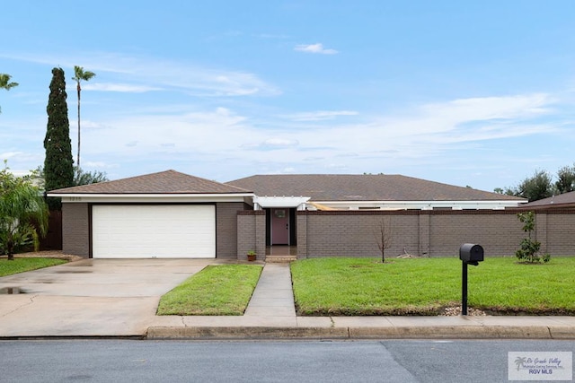 1215 Bluebonnet Dr, Brownsville, TX 78521 - view of front of home with a garage, driveway, and brick siding