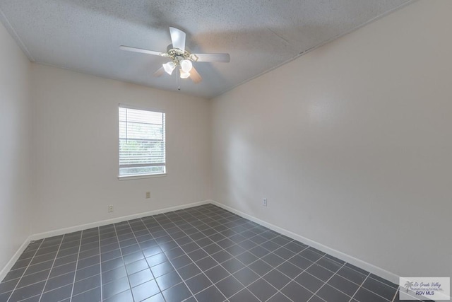 115 E Armstrong Ct, Brownsville, TX 78521 - unfurnished room with a ceiling fan, a textured ceiling, dark tile patterned floors, and baseboards
