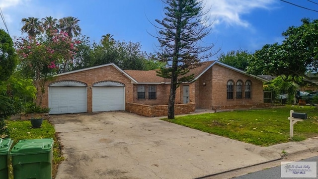 115 E Armstrong Ct, Brownsville, TX 78521 - ranch-style home with brick siding, an attached garage, a front yard, and concrete driveway