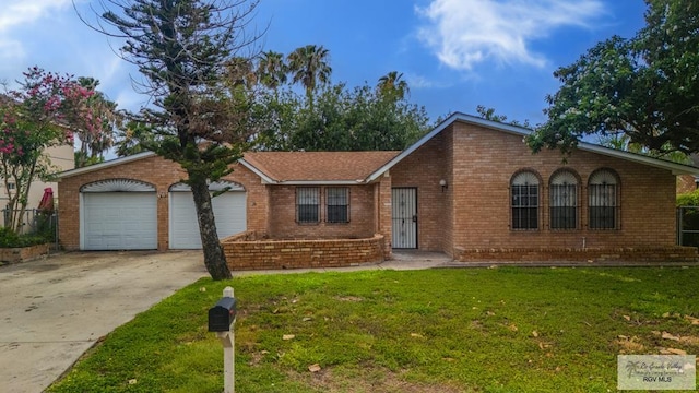 115 E Armstrong Ct, Brownsville, TX 78521 - single story home with driveway, a front yard, brick siding, and an attached garage